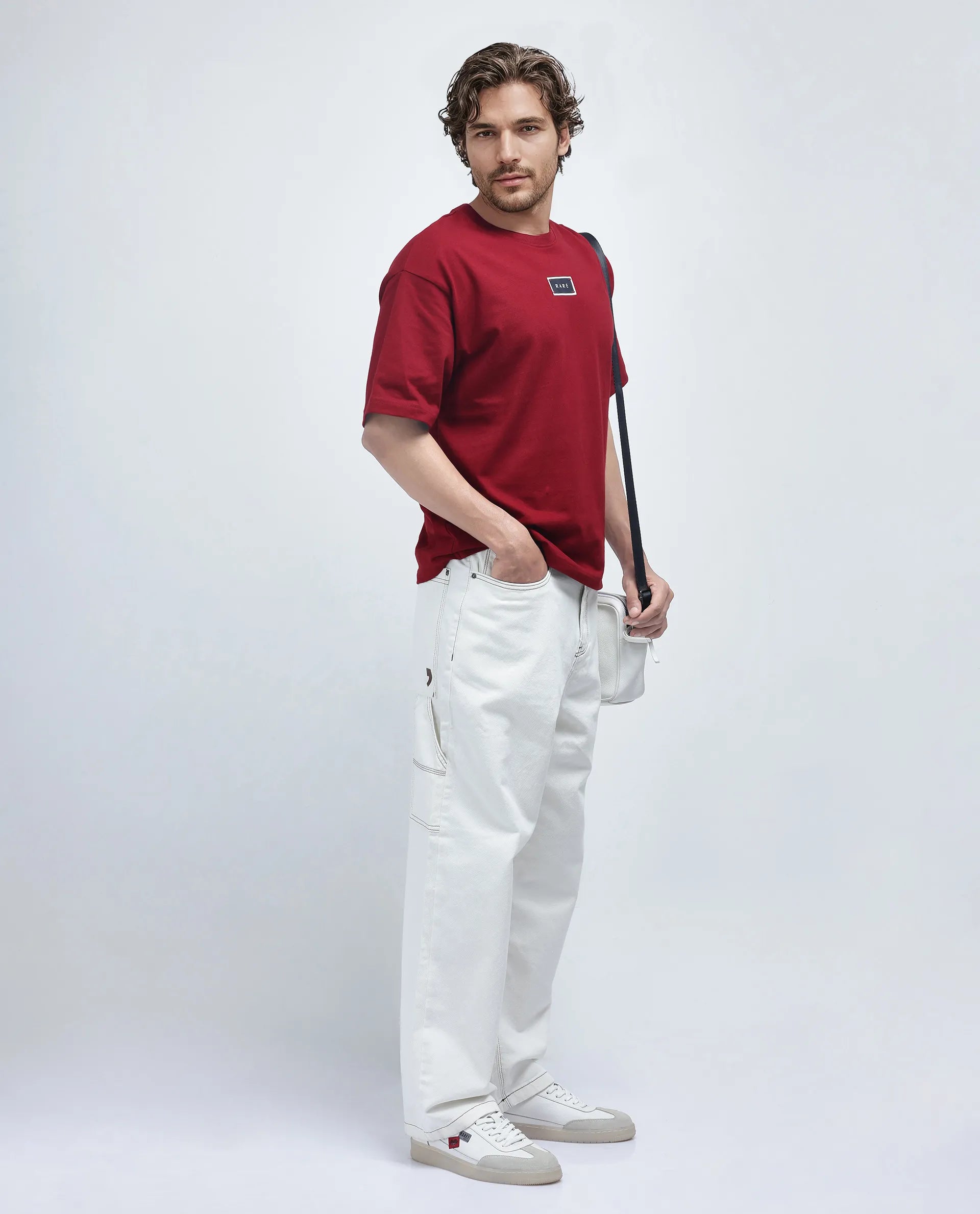 Everyday Casual Men's JeansRare Rabbit Men Cade White Cotton Fabric Button And Zip Closure Baggy Loose Fit Plain Jeans Everyday Casual Men's JeansRare Rabbit Men Cade White Cotton Fabric Button And Zip Closure Baggy Loose Fit Plain Jeans